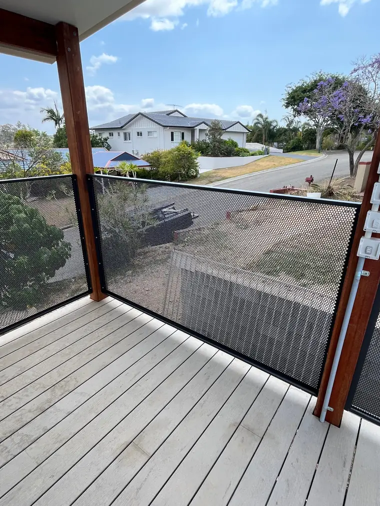 A plain balustrade between timber posts, keeping the street view open.