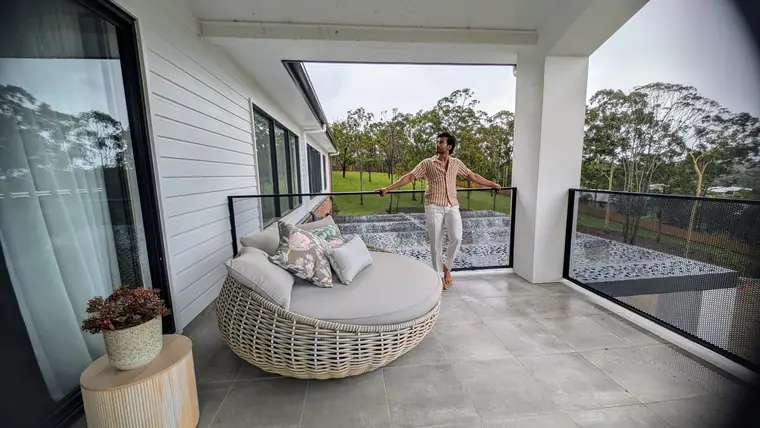 A covered balcony from inside. Seated or standing, you look straight through the balustrade.