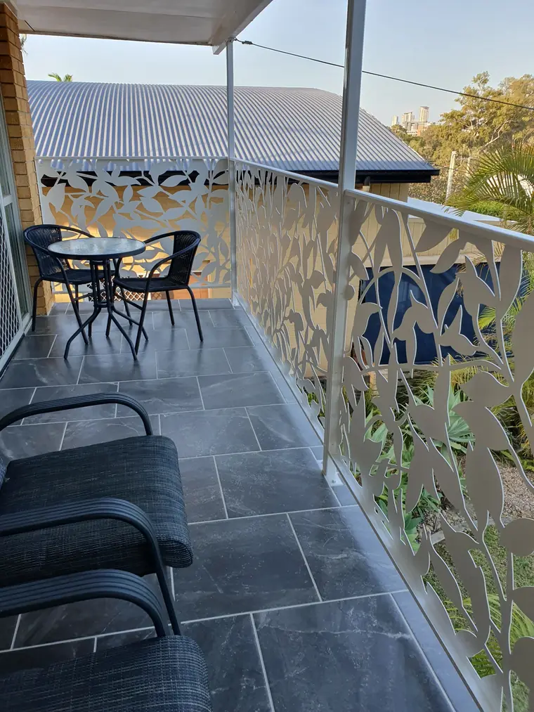 The same balcony from the inside, with room for two chairs and the view.