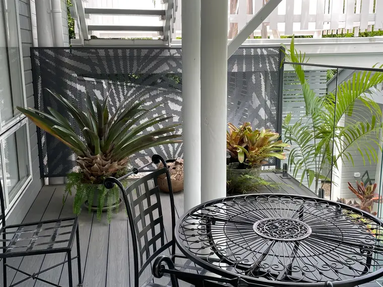 Palmy panels on a ground floor balcony.