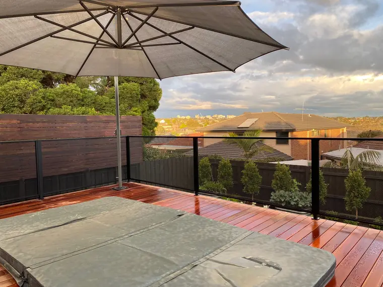A spa on a raised deck, and the city skyline straight through the balustrade.