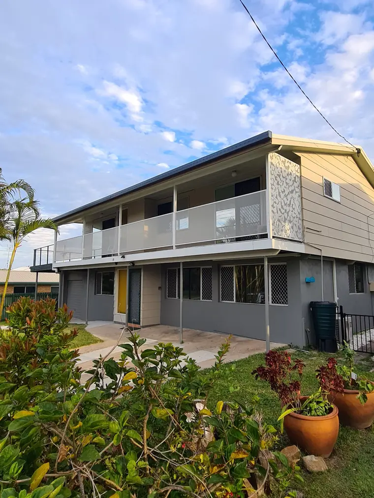 A pale balustrade on a two-storey home, with a feature panel at the end.