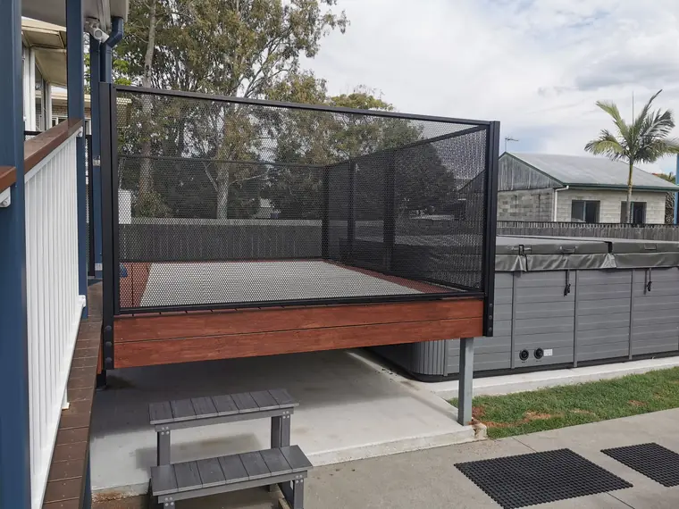 A raised timber deck beside a swim spa.