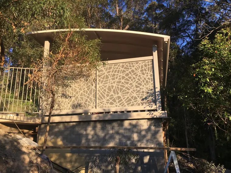 Swirl panels around a deck in the bush.