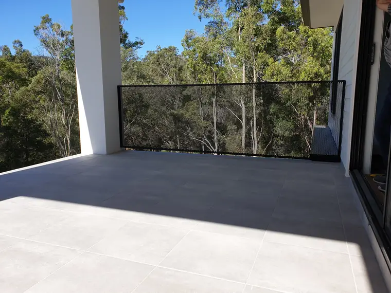 A top deck above the bush, with the trees showing through the balustrade.