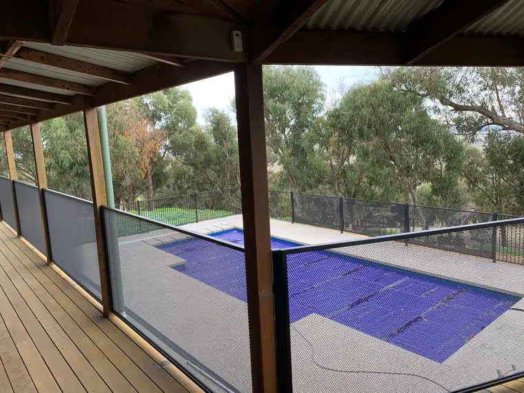 A verandah above a pool, with PoolPerf® as the balustrade.