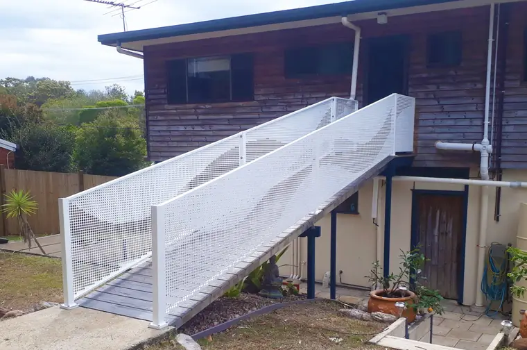 A custom white design running up both sides of an outside stair.