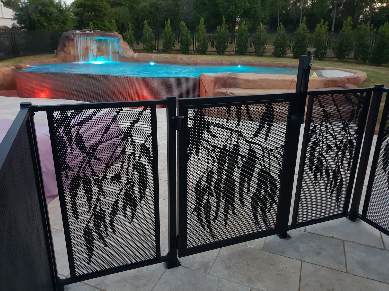 Gum Perf pool fencing and gate installed with the Bracket Fit system - fish-mouth shroud brackets clamp the panels to the posts