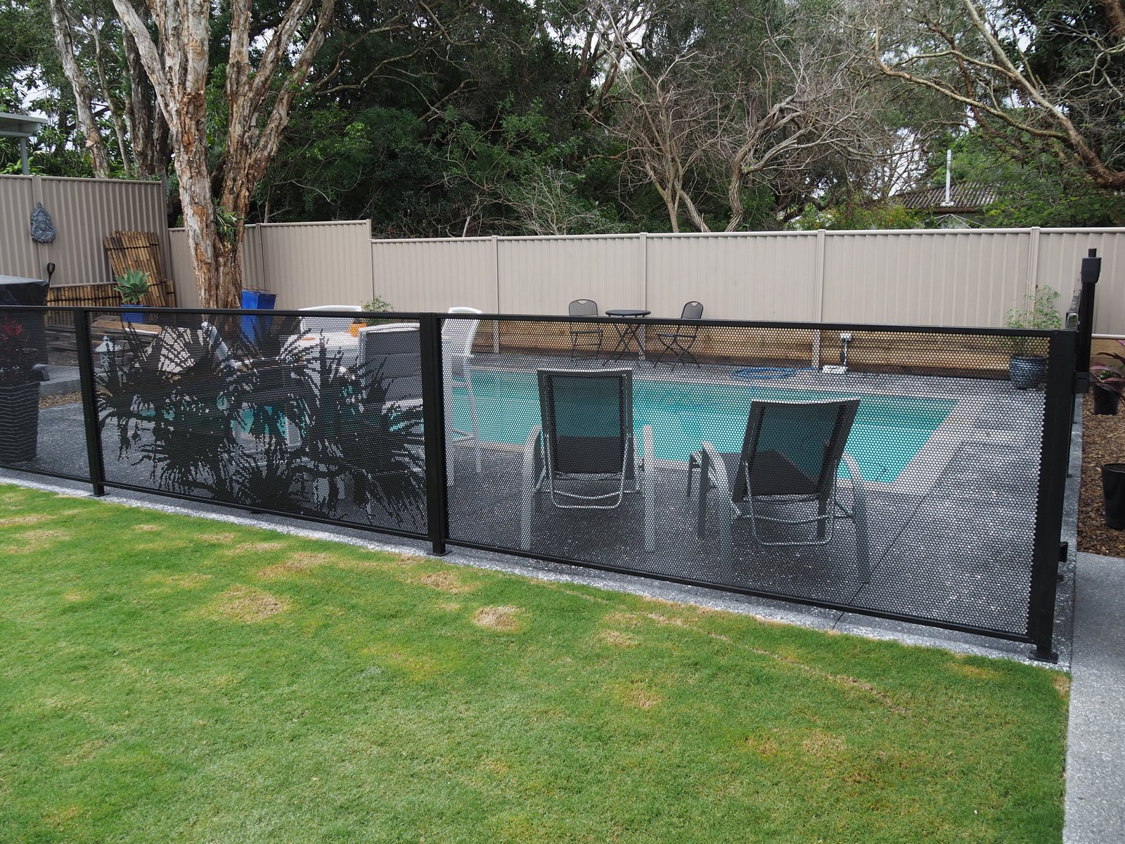 Pandanus Perf pool fencing installed with the Channel Fit system - panels sit into channels on the posts, no visible brackets