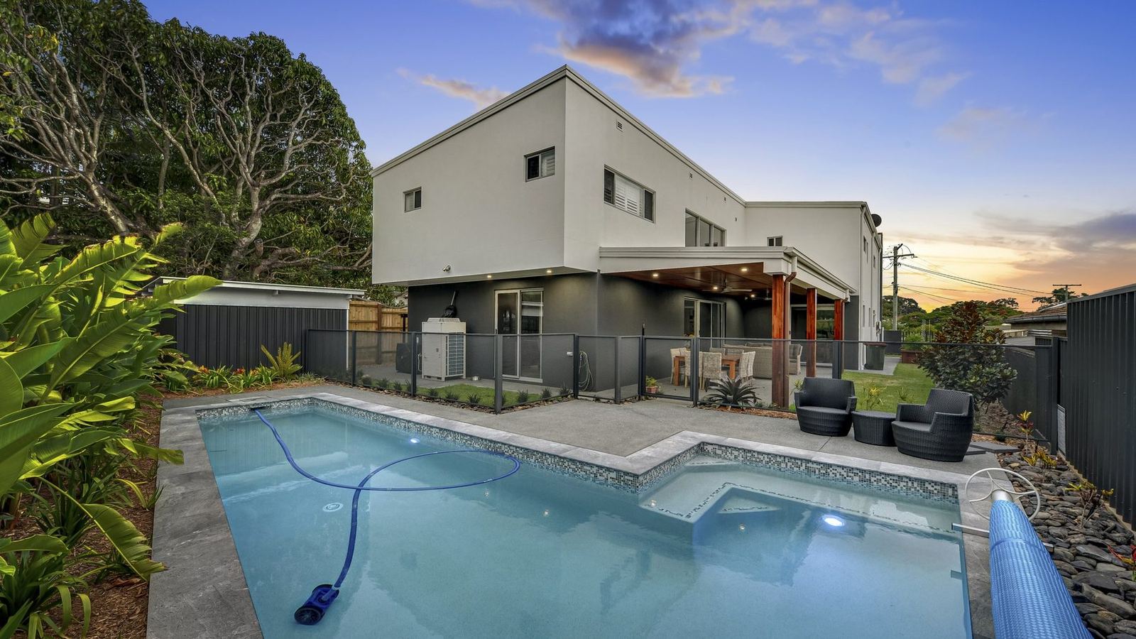 Pool Perf pool fencing around a modern Australian home at twilight